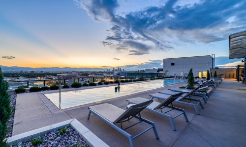 a rooftop pool with lounge chairs