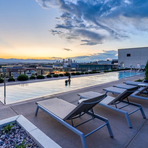 a rooftop pool with lounge chairs