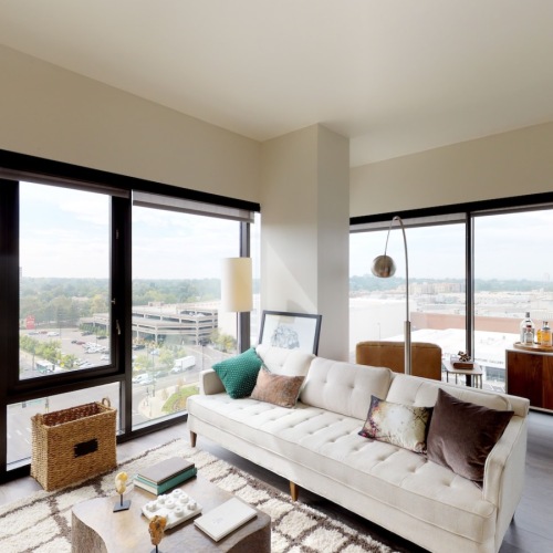 a living room with a couch and large windows