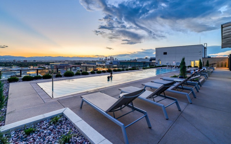 a rooftop pool with lounge chairs