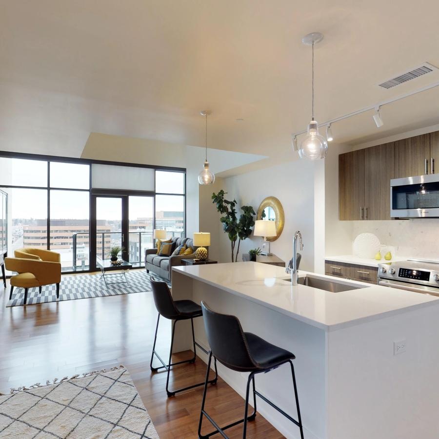 a kitchen with an island and chairs