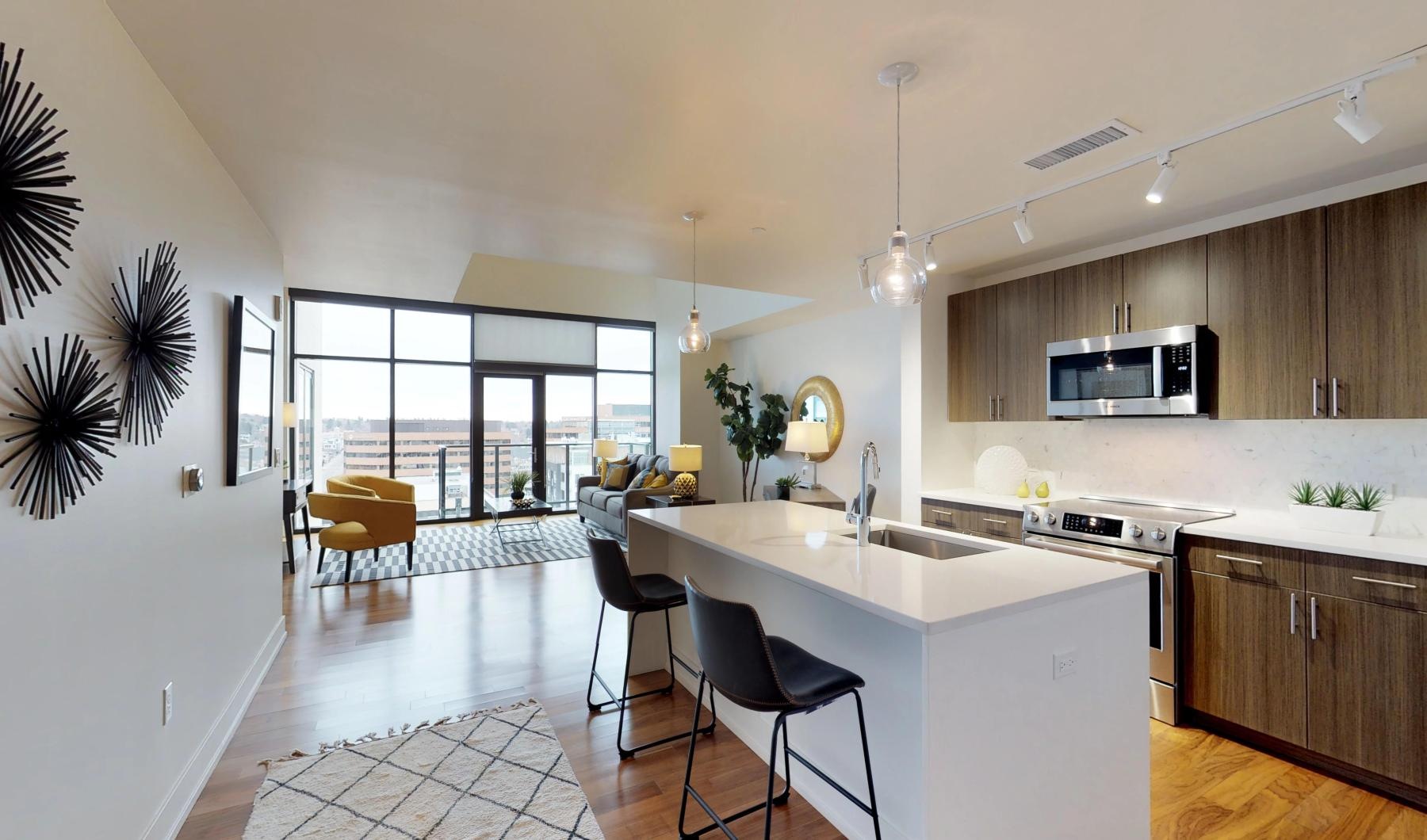 a kitchen with an island and chairs