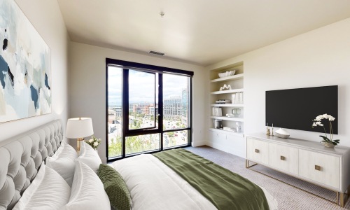 a bedroom with a bed and a tv on a dresser